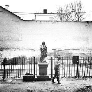 Full length of woman standing on railing