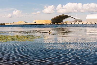 Scenic view of sea by building against sky