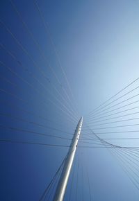 Low angle view of bridge against clear blue sky