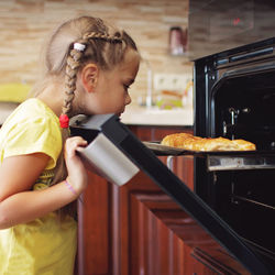 Cute girl looking at baked pie