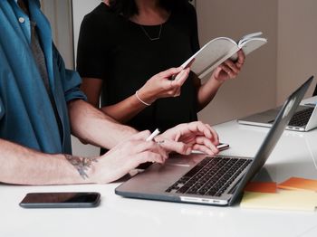 Midsection of woman working on table