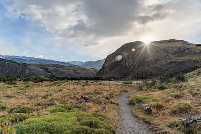 Scenic view of landscape and mountains against sky