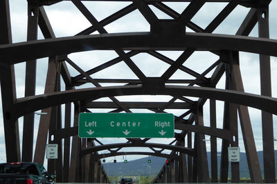 Low angle view of road sign against sky