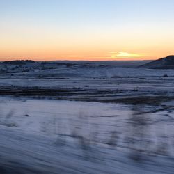 Scenic view of frozen sea against sky during sunset