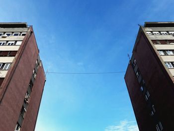 Low angle view of buildings against blue sky