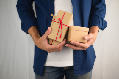 Midsection of man holding paper in box