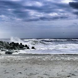 Scenic view of sea against cloudy sky