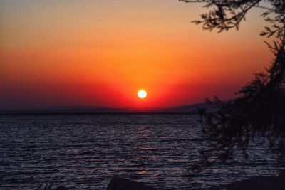 Scenic view of sea against orange sky