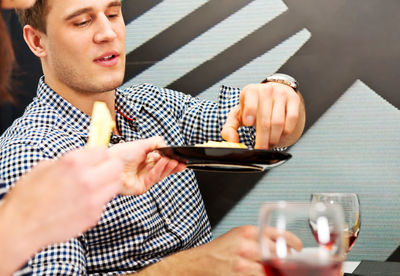 Midsection of man sitting on table