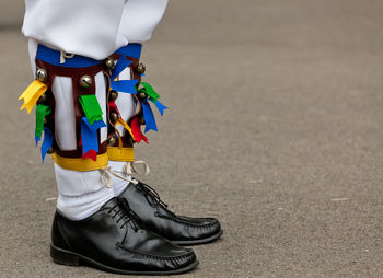 Low section of man wearing shoes