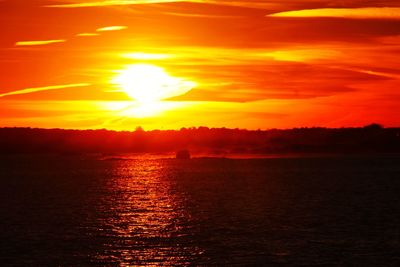 Scenic view of sea against romantic sky at sunset