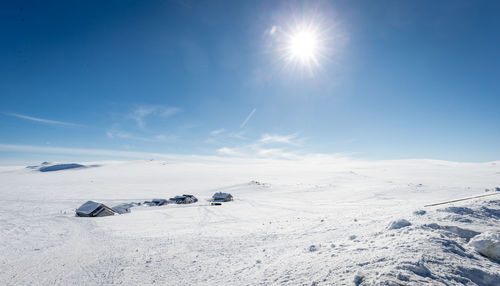 Scenic view of snowcapped mountains against sky on sunny day