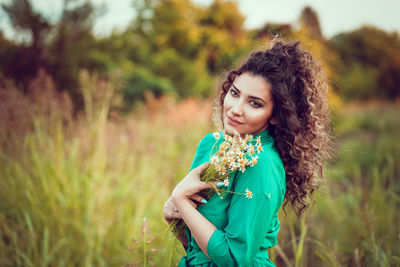 Portrait of woman standing on field