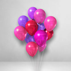 Close-up of multi colored balloons against white background