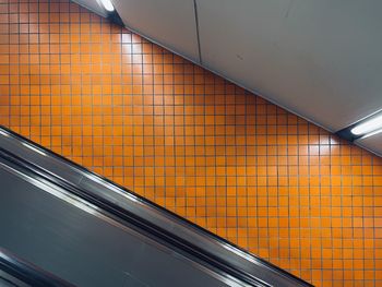 Tilted iew of escalator and orange tile background at nuremberg main station