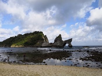 Rocks on beach against sky