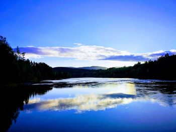 Scenic view of lake against blue sky