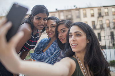 Young women taking a selfie at a party together