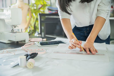 Midsection of woman working on table