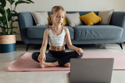 Young woman exercising at home