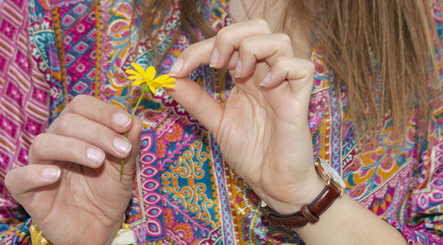 Midsection of woman holding flower