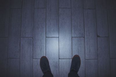 Low section of people standing on tiled floor