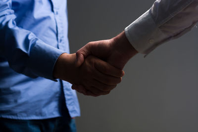 Close-up of hands against white background