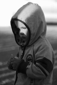 Close-up of boy wearing hooded shirt