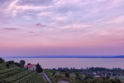 Scenic view of lake balaton by town against cloudy sky