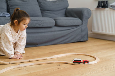 Cute girl playing with toy at home