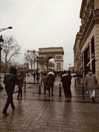 People walking on street in rain