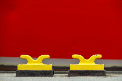 Close-up of yellow mooring hooks on jetty