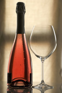 Close-up of red wine bottle and glass on table