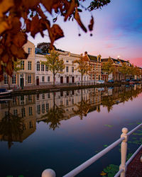 Reflection of buildings in lake against sky