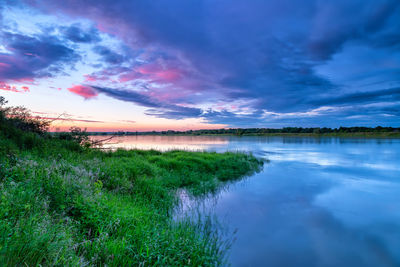 Scenic view of river wisla against sky during sunset