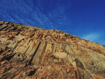 Low angle view of rock formations against blue sky