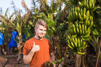 Man standing by tree against plants