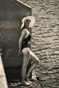 Low section of woman sitting on pier