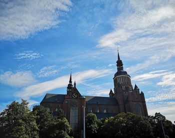 View of buildings against cloudy sky