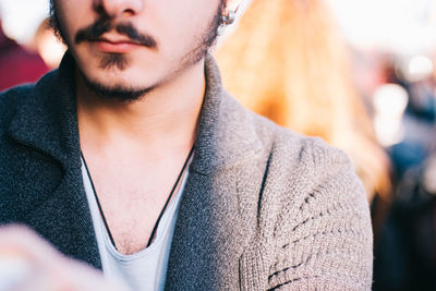 Midsection of man wearing jacket