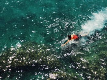 High angle view of man swimming in sea