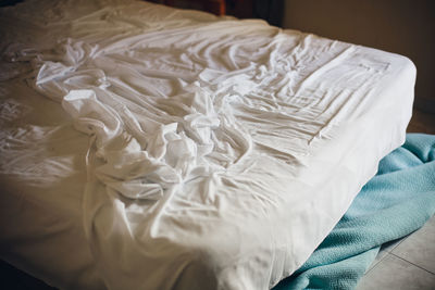 High angle view of white fabric on bed
