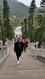 Portrait of woman walking on road