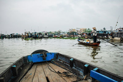 Boat moored on river against sky