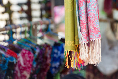 Close-up of multi colored clothes hanging for sale