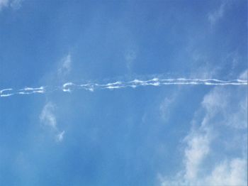 Low angle view of vapor trail in blue sky