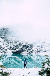 People standing near a glacial lake