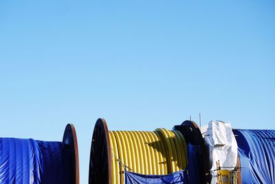 Low angle view of clothes drying against blue sky