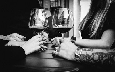 People in drinking glass on table