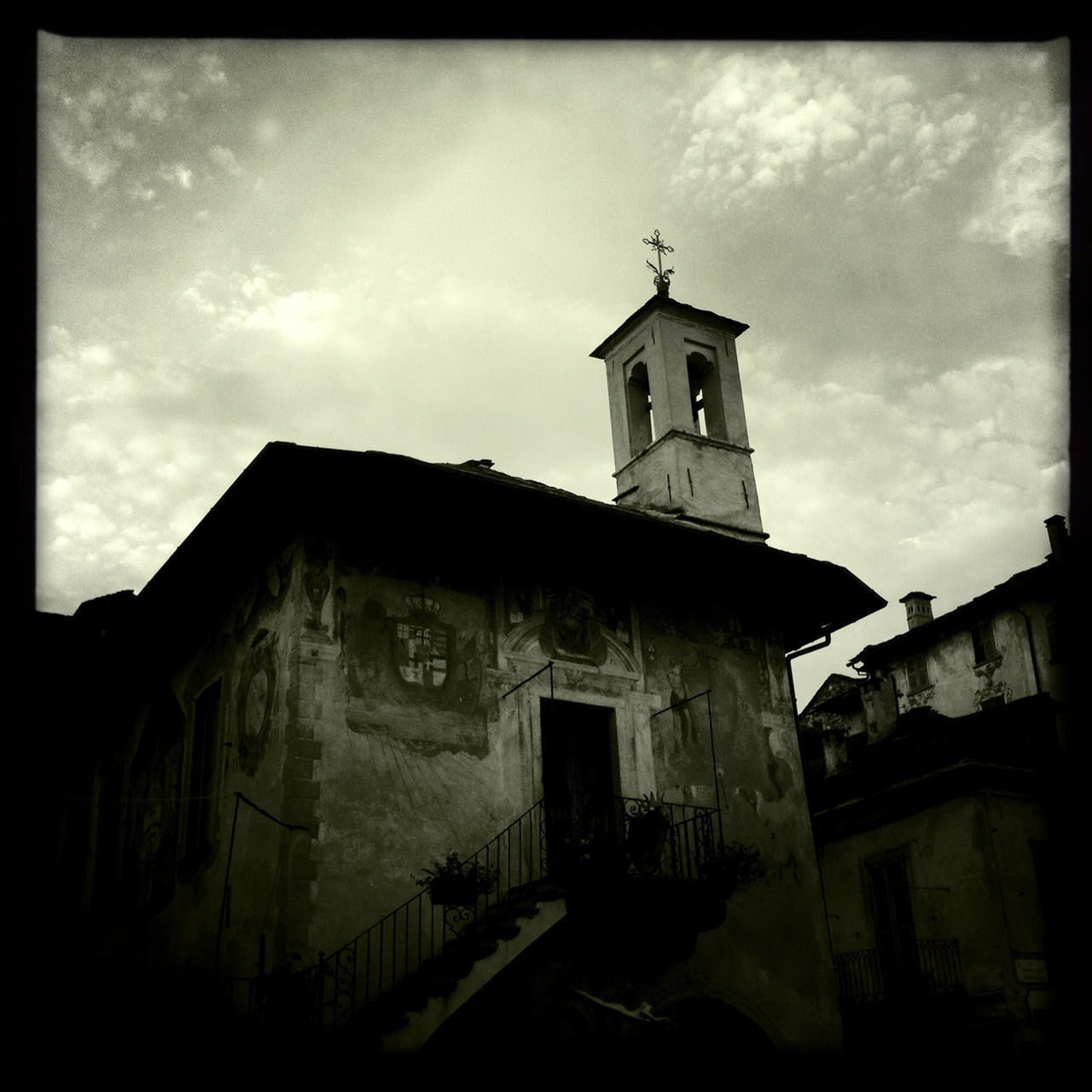 architecture, building exterior, built structure, sky, church, religion, low angle view, place of worship, transfer print, auto post production filter, spirituality, cloud - sky, house, cloud, residential structure, cross, old, cloudy